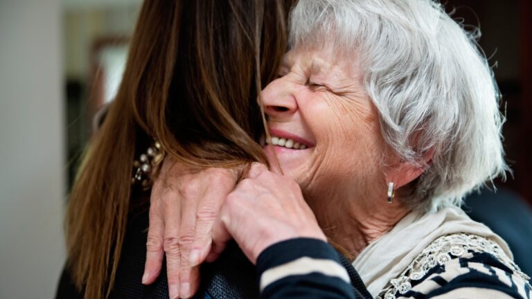 Elderly women embracing a hug