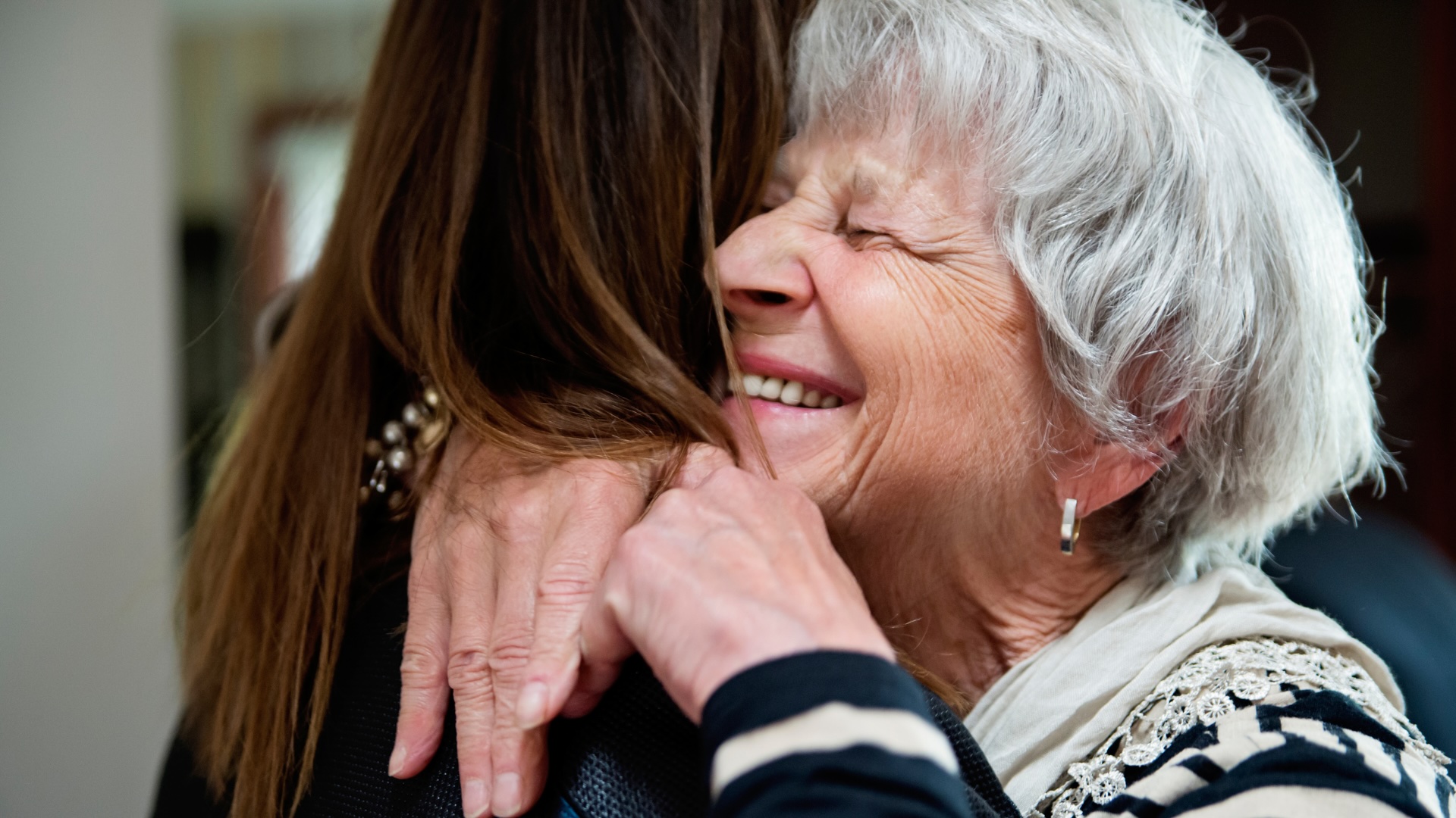 Elderly women embracing a hug
